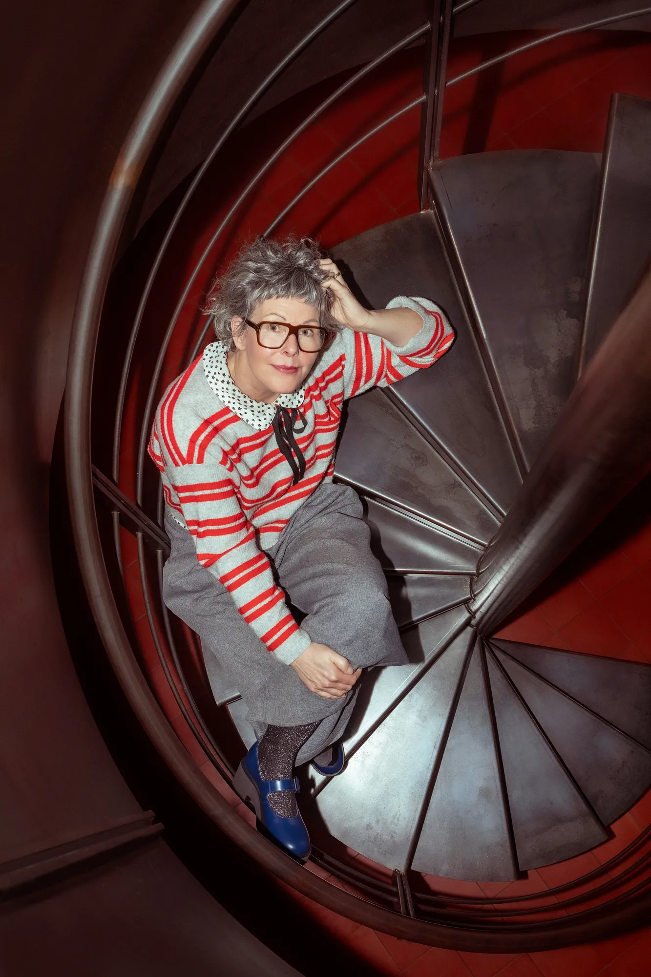 Editorial portrait on a spiral staircase