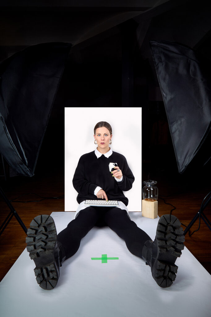 A creative portrait of Emily wild. Low angle, distorted perspective drinking coffee